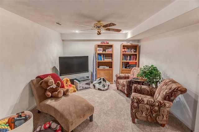 carpeted living room featuring ceiling fan