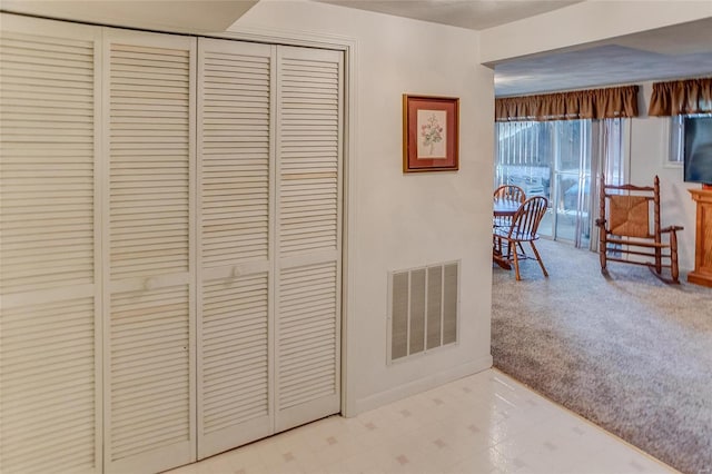 corridor with light colored carpet