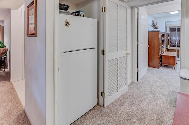 corridor featuring light colored carpet