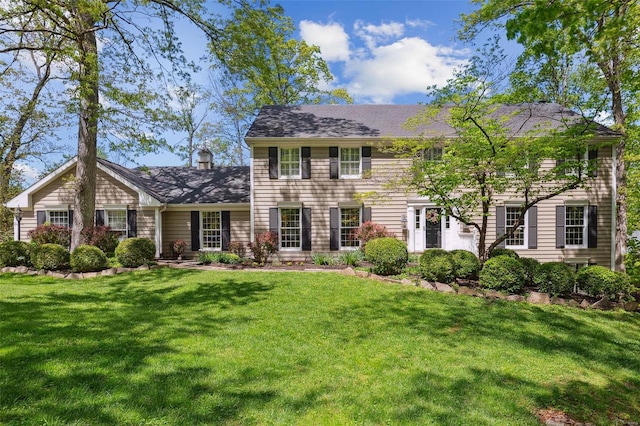 colonial inspired home with a front lawn