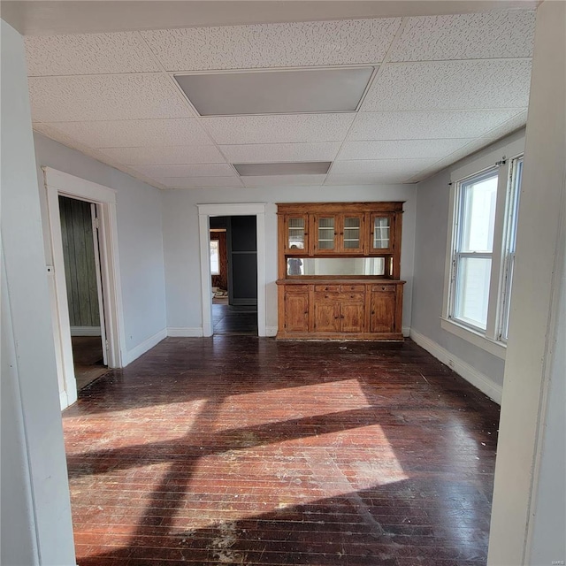 unfurnished living room featuring a paneled ceiling