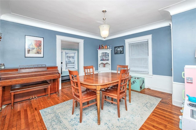 dining room with dark wood-type flooring and ornamental molding