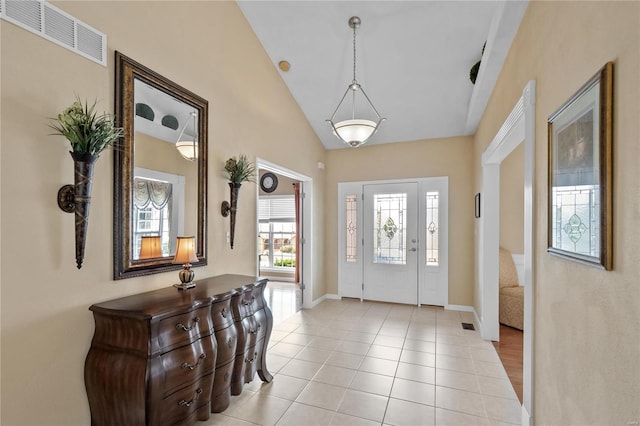 tiled entryway with vaulted ceiling