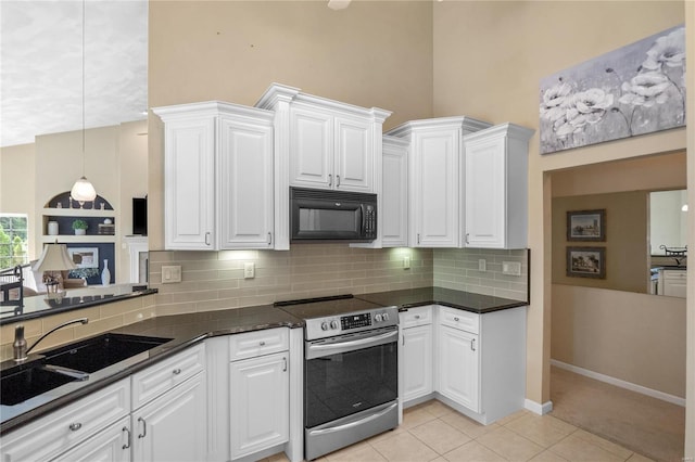 kitchen with backsplash, sink, stainless steel electric range, white cabinetry, and light tile patterned flooring