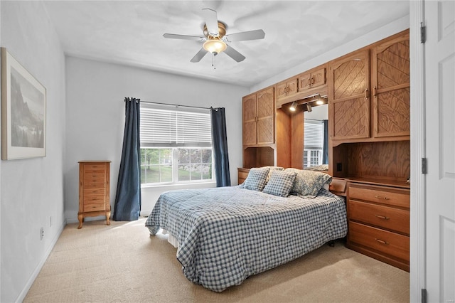 bedroom featuring light carpet and ceiling fan