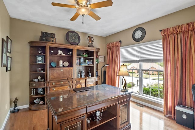 home office with ceiling fan and light hardwood / wood-style floors