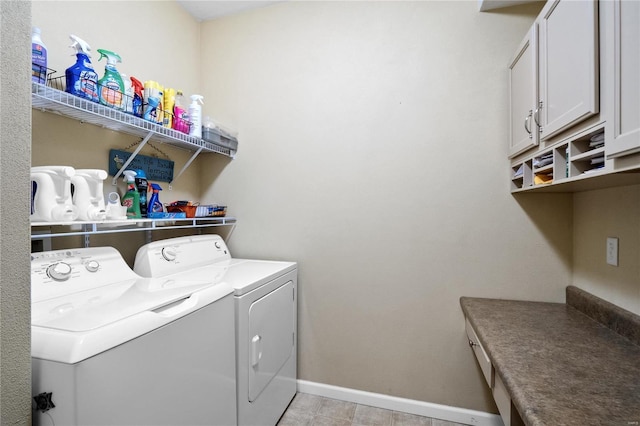 washroom featuring cabinets and separate washer and dryer