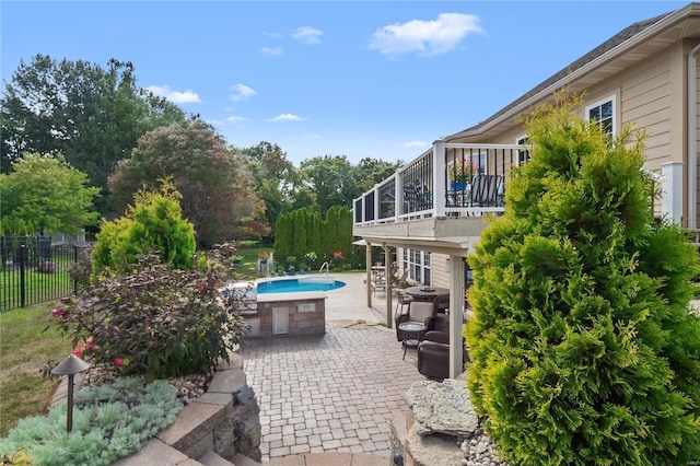 view of patio / terrace featuring a sunroom and a fenced in pool