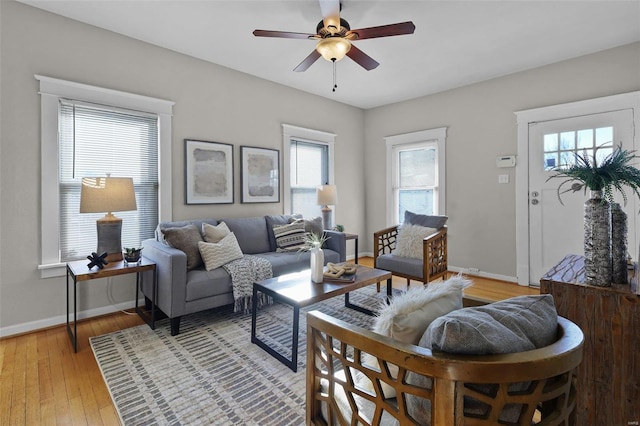 living room with light wood-type flooring and ceiling fan