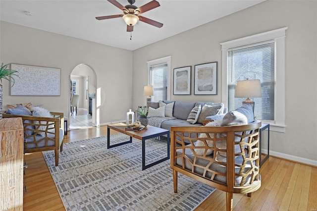 living room featuring light wood-type flooring and ceiling fan