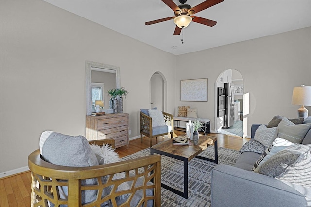 living room featuring ceiling fan and light hardwood / wood-style flooring