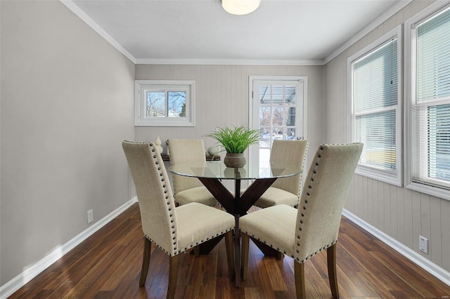 dining area with dark wood-type flooring, ornamental molding, and a healthy amount of sunlight