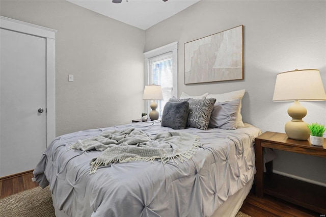 bedroom with dark wood-type flooring