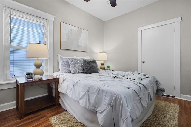 bedroom with ceiling fan and dark wood-type flooring