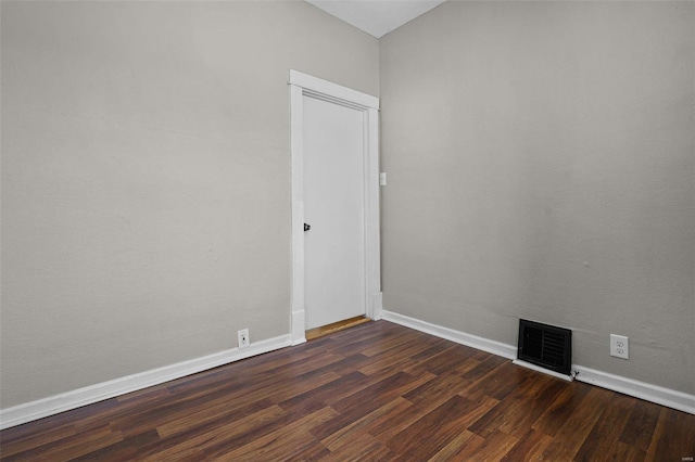 spare room featuring dark wood-type flooring