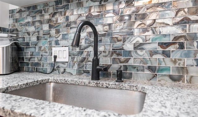 details featuring sink and stone countertops