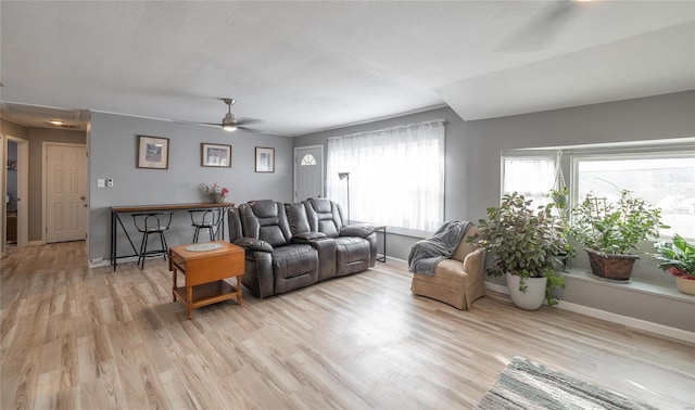 living room with ceiling fan and light hardwood / wood-style floors