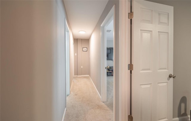 hall with light colored carpet