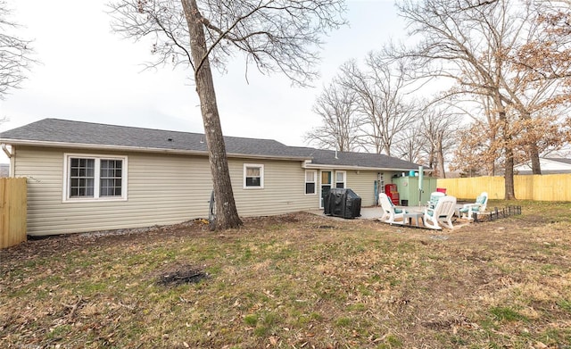 rear view of property with a lawn