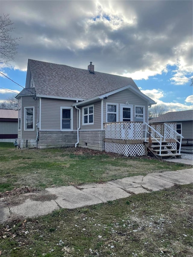 rear view of property with a lawn