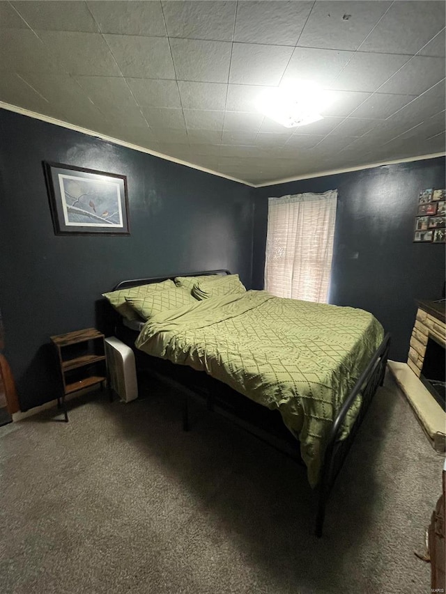 carpeted bedroom featuring a fireplace and ornamental molding