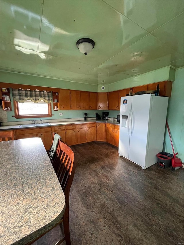 kitchen with white fridge with ice dispenser and sink