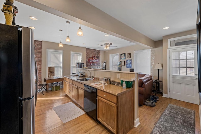 kitchen with dishwasher, sink, light hardwood / wood-style flooring, ceiling fan, and stainless steel fridge