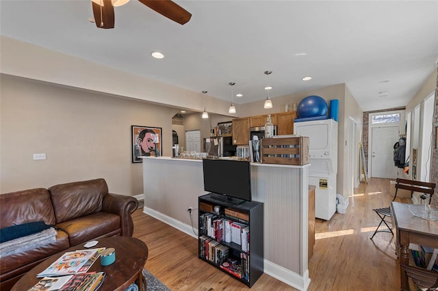 living room with ceiling fan and light wood-type flooring