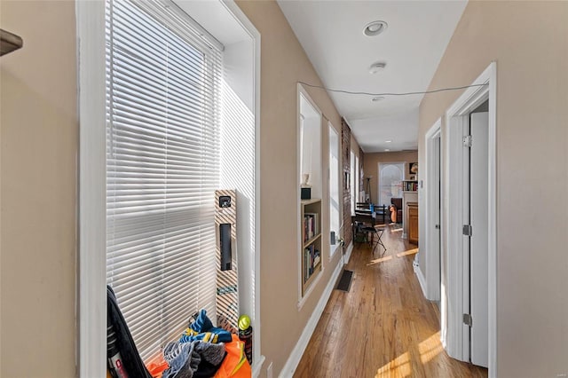 hallway with light hardwood / wood-style flooring