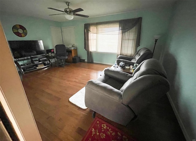 living room featuring hardwood / wood-style flooring and ceiling fan