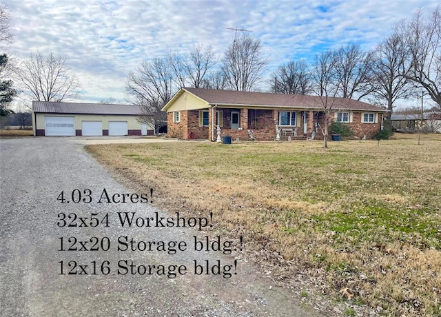 single story home featuring a garage, an outdoor structure, and a front yard