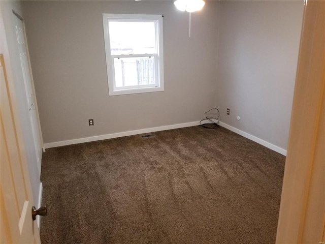 empty room with dark carpet