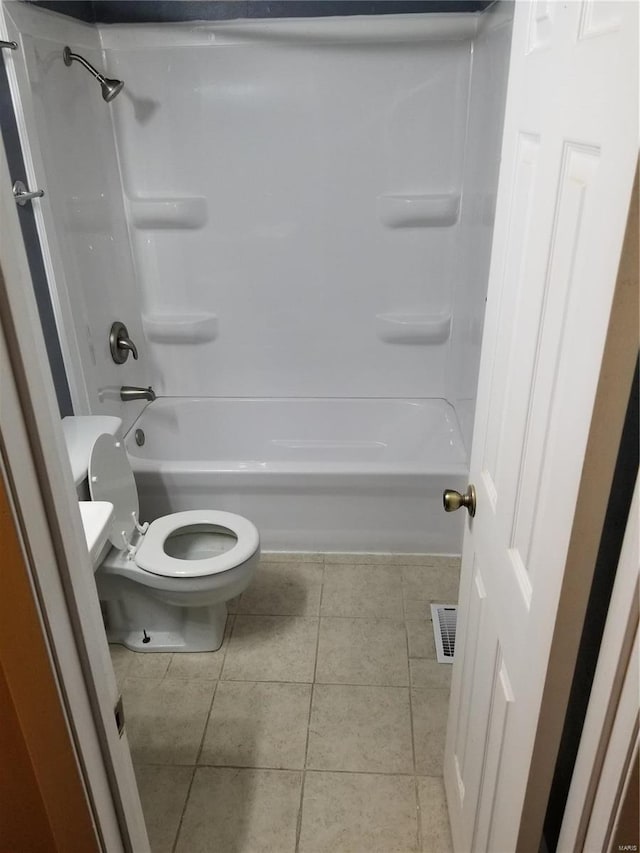 bathroom with tile patterned flooring, toilet, and shower / bath combination