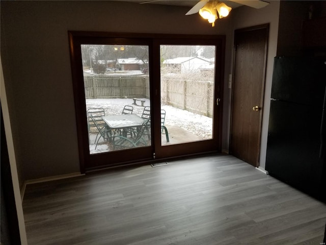 entryway with hardwood / wood-style floors and ceiling fan