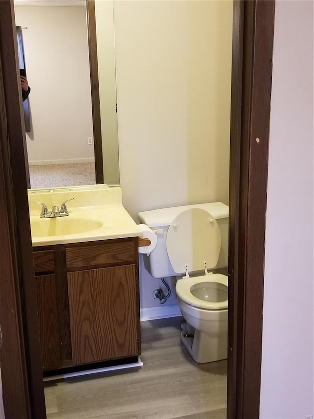 bathroom featuring hardwood / wood-style floors, vanity, and toilet