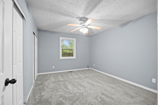 unfurnished bedroom featuring baseboards, carpet flooring, and a textured ceiling