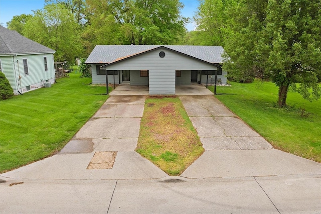 view of front of property with an attached carport, a front yard, and concrete driveway