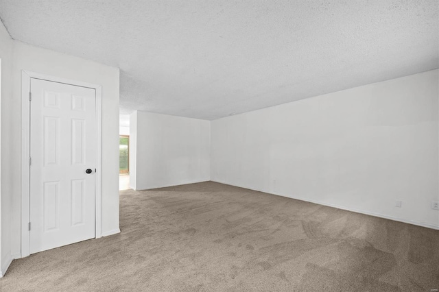 unfurnished room featuring carpet floors and a textured ceiling