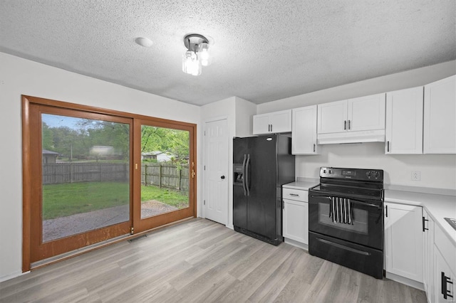 kitchen with light wood-style floors, light countertops, under cabinet range hood, white cabinets, and black appliances