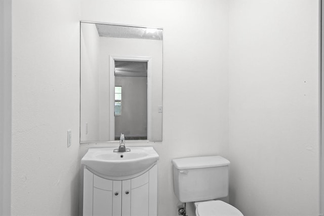 bathroom with toilet and vanity