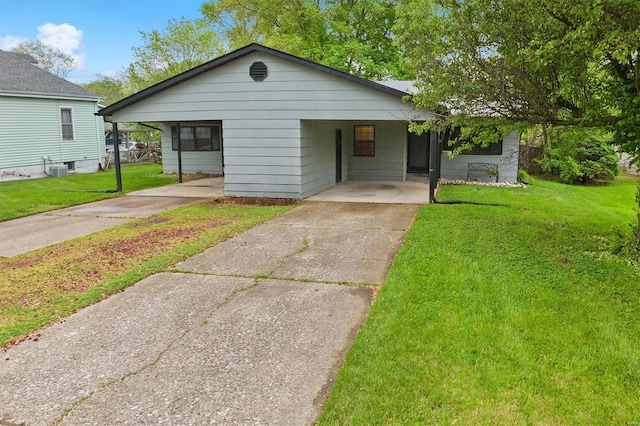 view of front of property with a carport, concrete driveway, and a front yard