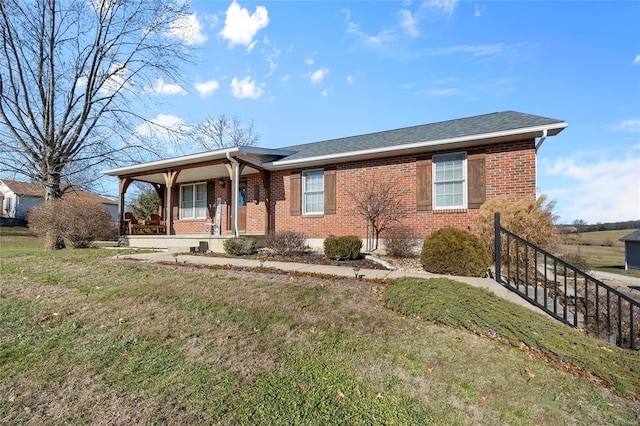 single story home with roof with shingles, a front lawn, a porch, and brick siding