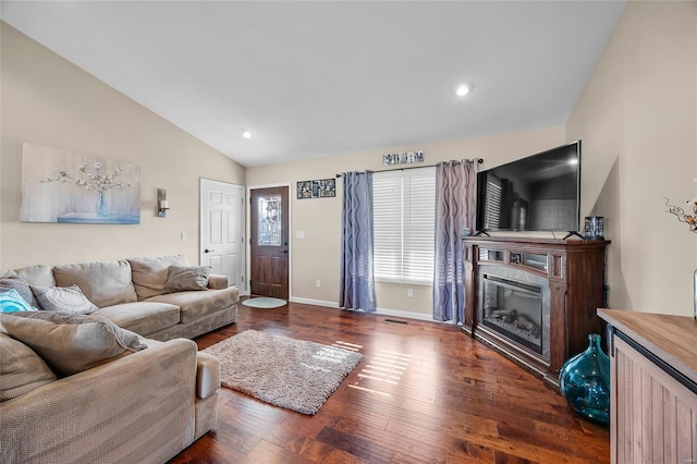 living area with recessed lighting, wood finished floors, baseboards, vaulted ceiling, and a glass covered fireplace