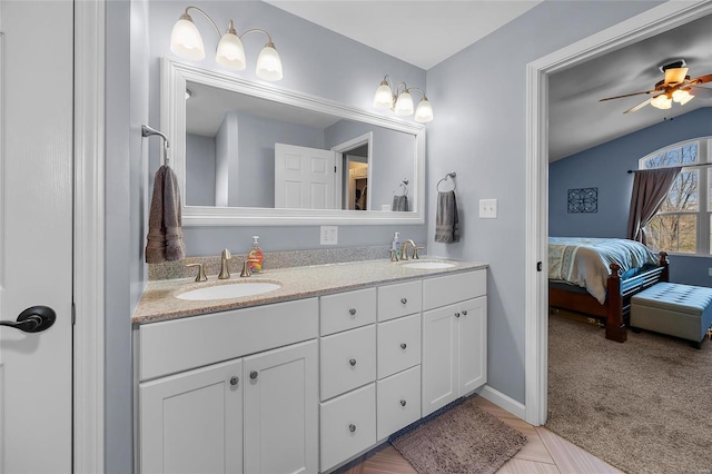 ensuite bathroom with ceiling fan, double vanity, a sink, and ensuite bathroom