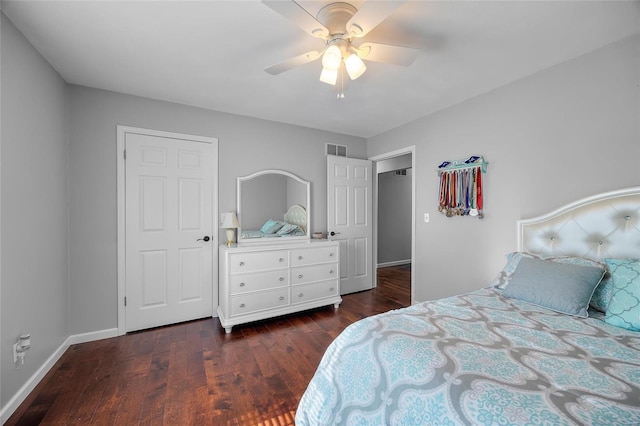 bedroom featuring a ceiling fan, visible vents, baseboards, and wood finished floors