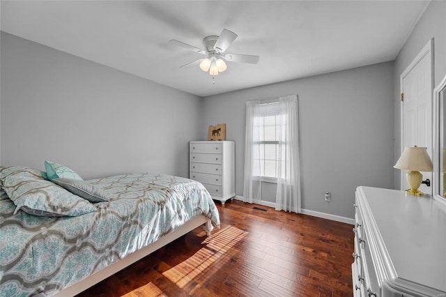 bedroom featuring dark wood-style floors, ceiling fan, and baseboards