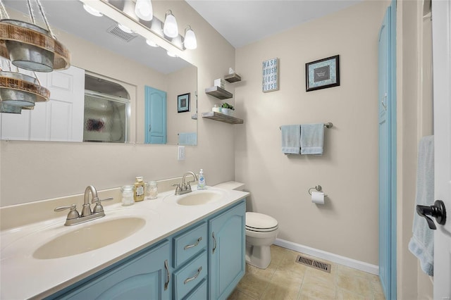 bathroom featuring a stall shower, a sink, and visible vents