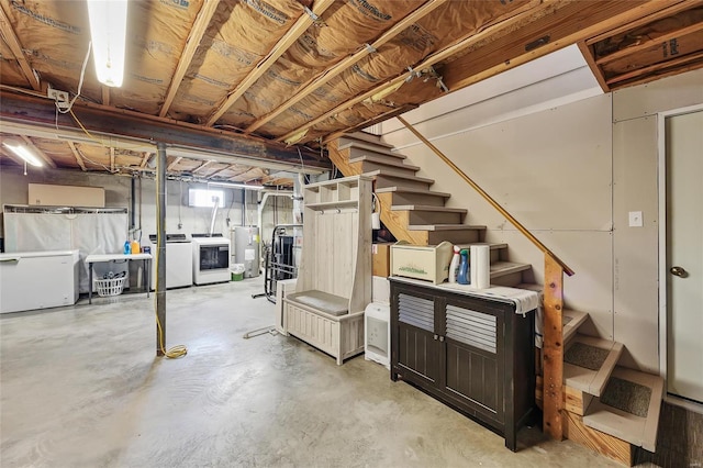 below grade area with refrigerator, stairway, washing machine and clothes dryer, and electric water heater