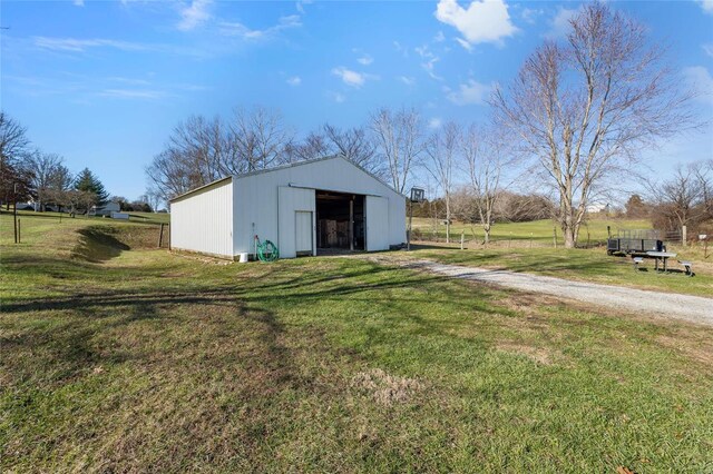 view of pole building with a yard and driveway