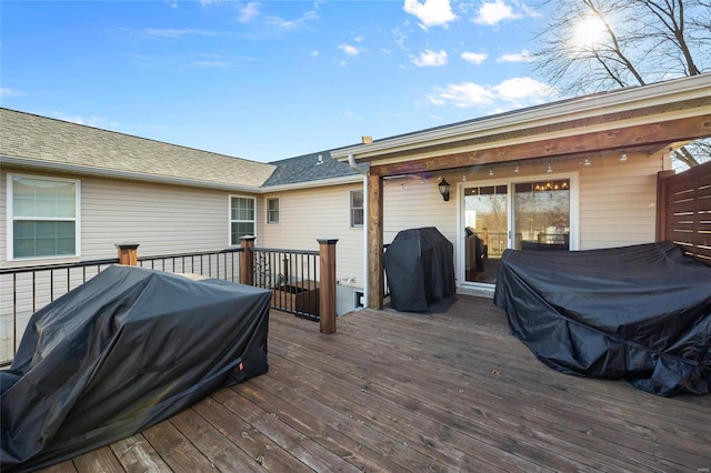 wooden terrace featuring a grill